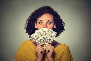 woman-with-money-fanned-in-front-of-face